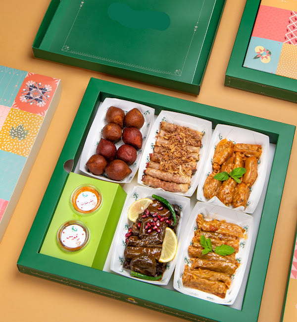 Assorted food items in a green box on a colorful background