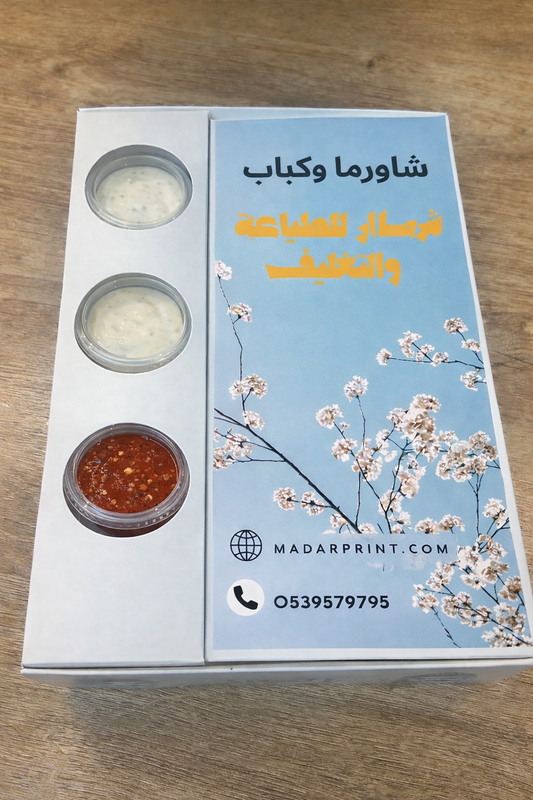 Product packaging with floral design and text on a wooden surface