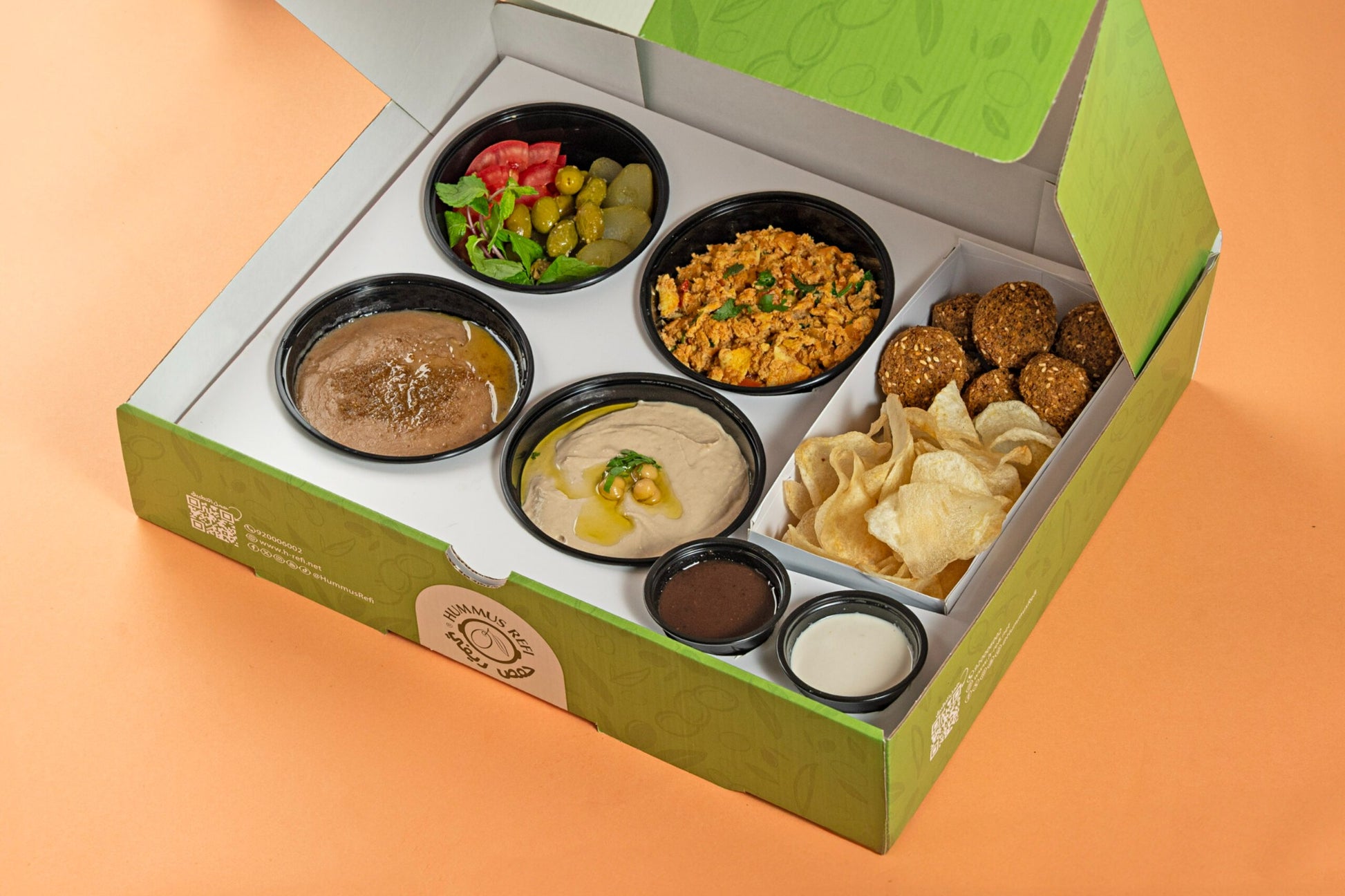 Assorted small dishes in a green box on an orange background