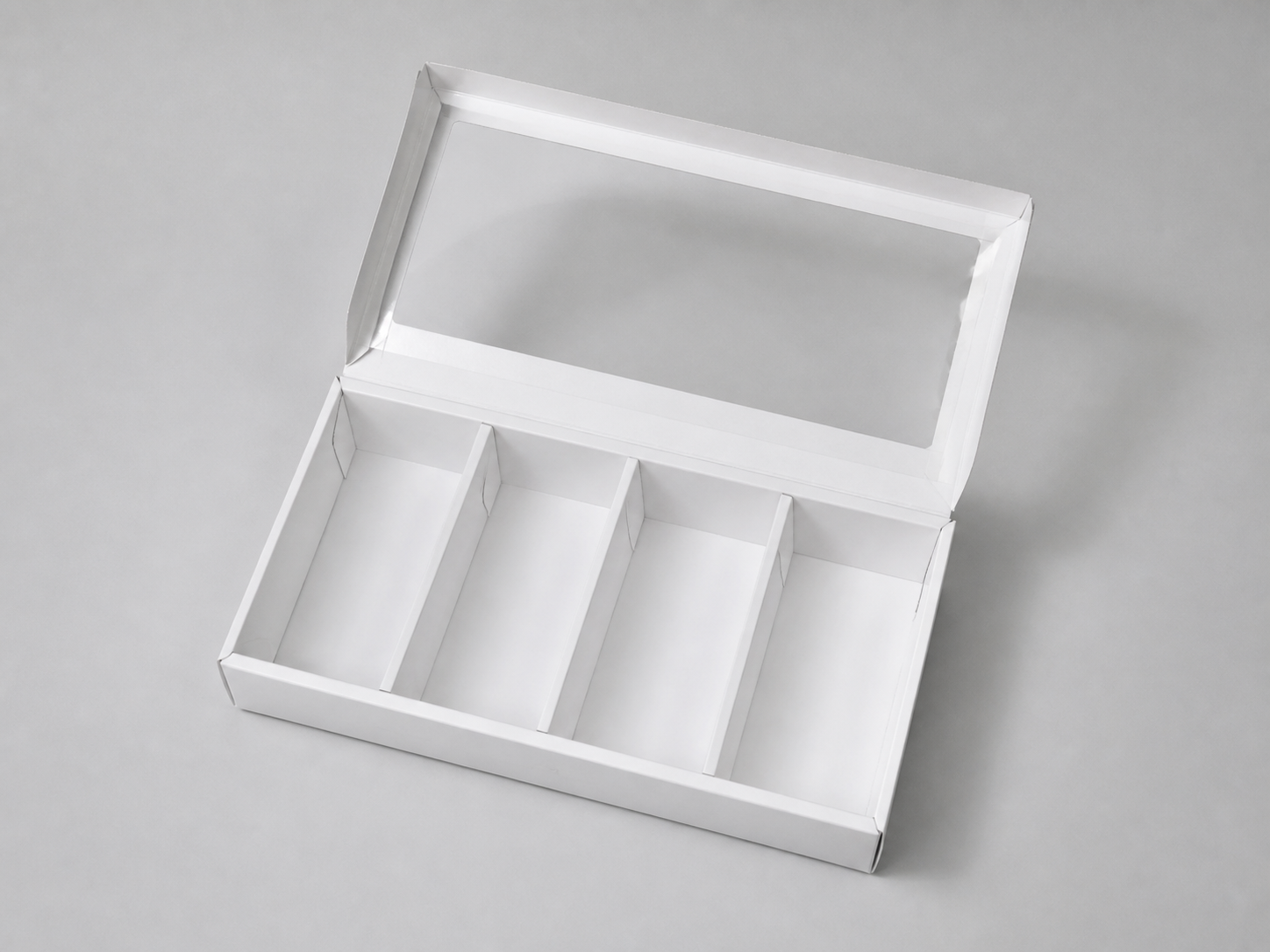 Open empty four-compartment bakery pie box with transparent lid from a different angle