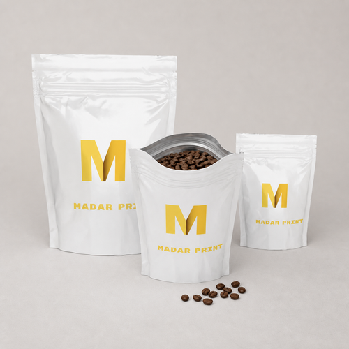 Three sizes of printed coffee pouches with the medium pouch open and filled with roasted beans