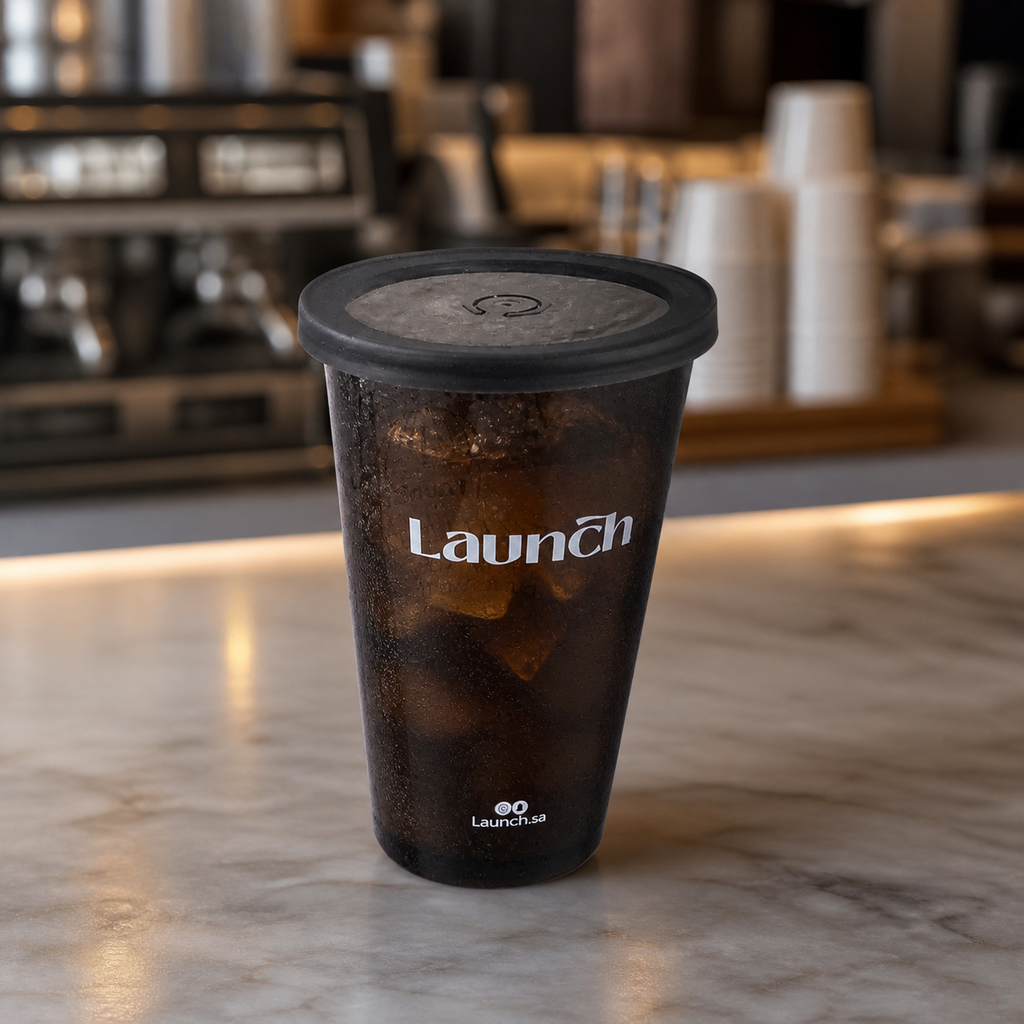 Custom black 12 oz plastic cup filled with iced coffee