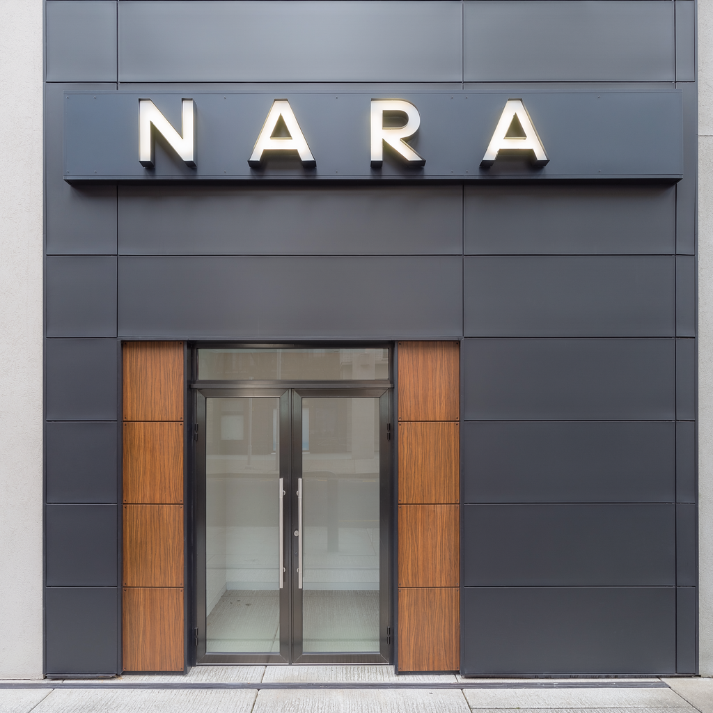 Custom illuminated 3D letters installed on a dark ACP sign tray above a storefront entrance
