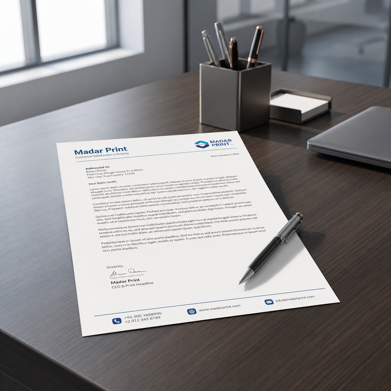 Custom letterhead sheet in use on a modern office desk