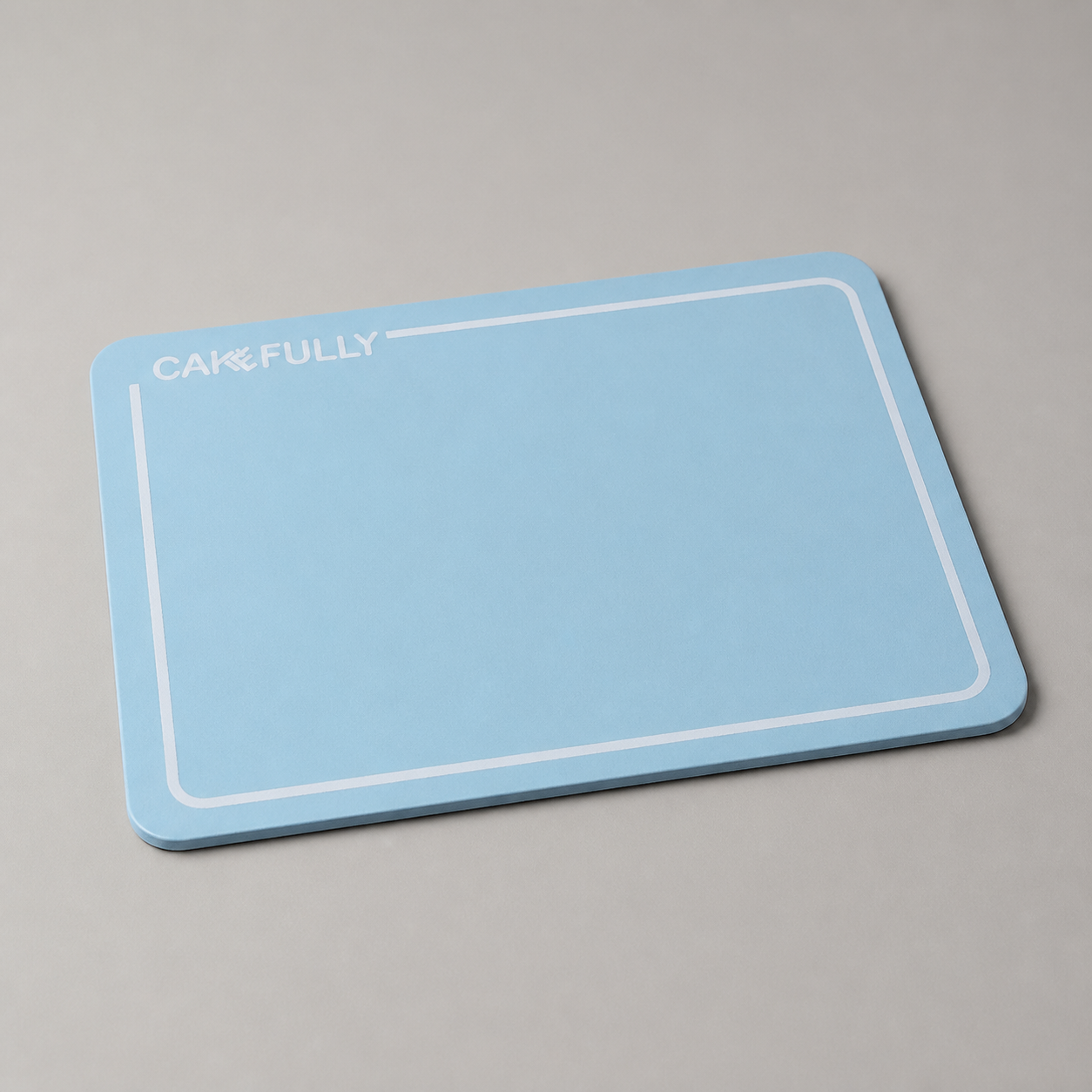 Customized rectangular cake board shown empty from a low angle