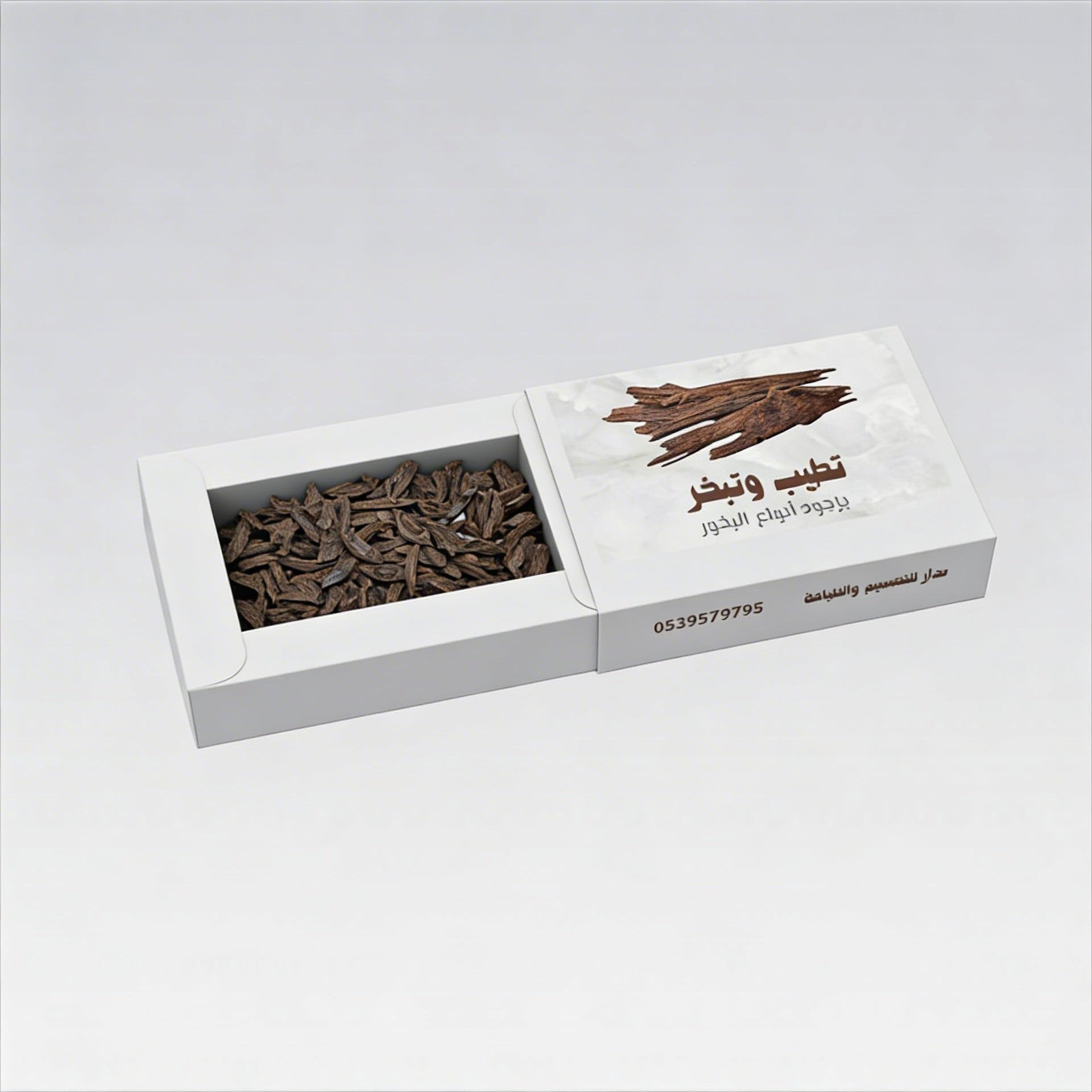 A box of premium oud wood chips for incense, rich brown color, enhances ambiance with aromatic fragrance.