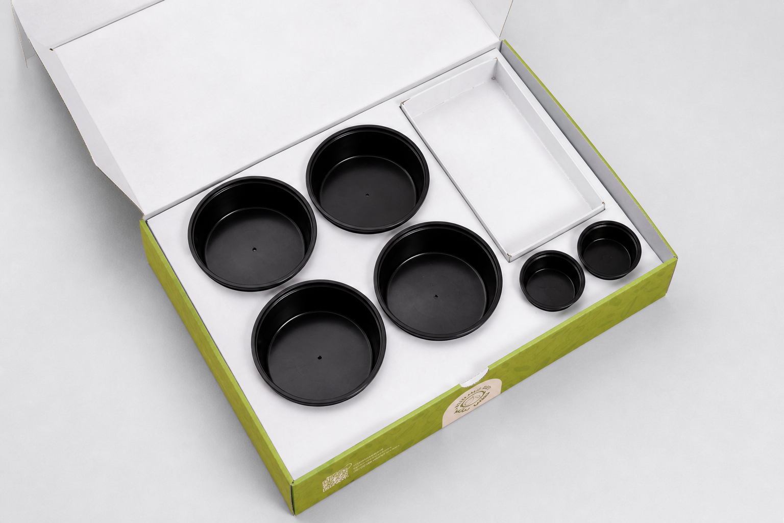 Open empty green multi-compartment catering meal box shown from a different angle
