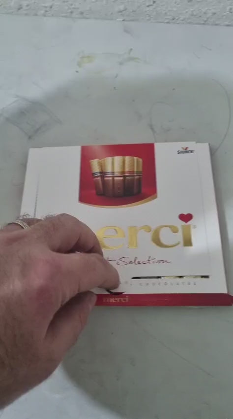 Merci chocolate gift selection box with assorted pralines, elegant design, perfect for gifting.