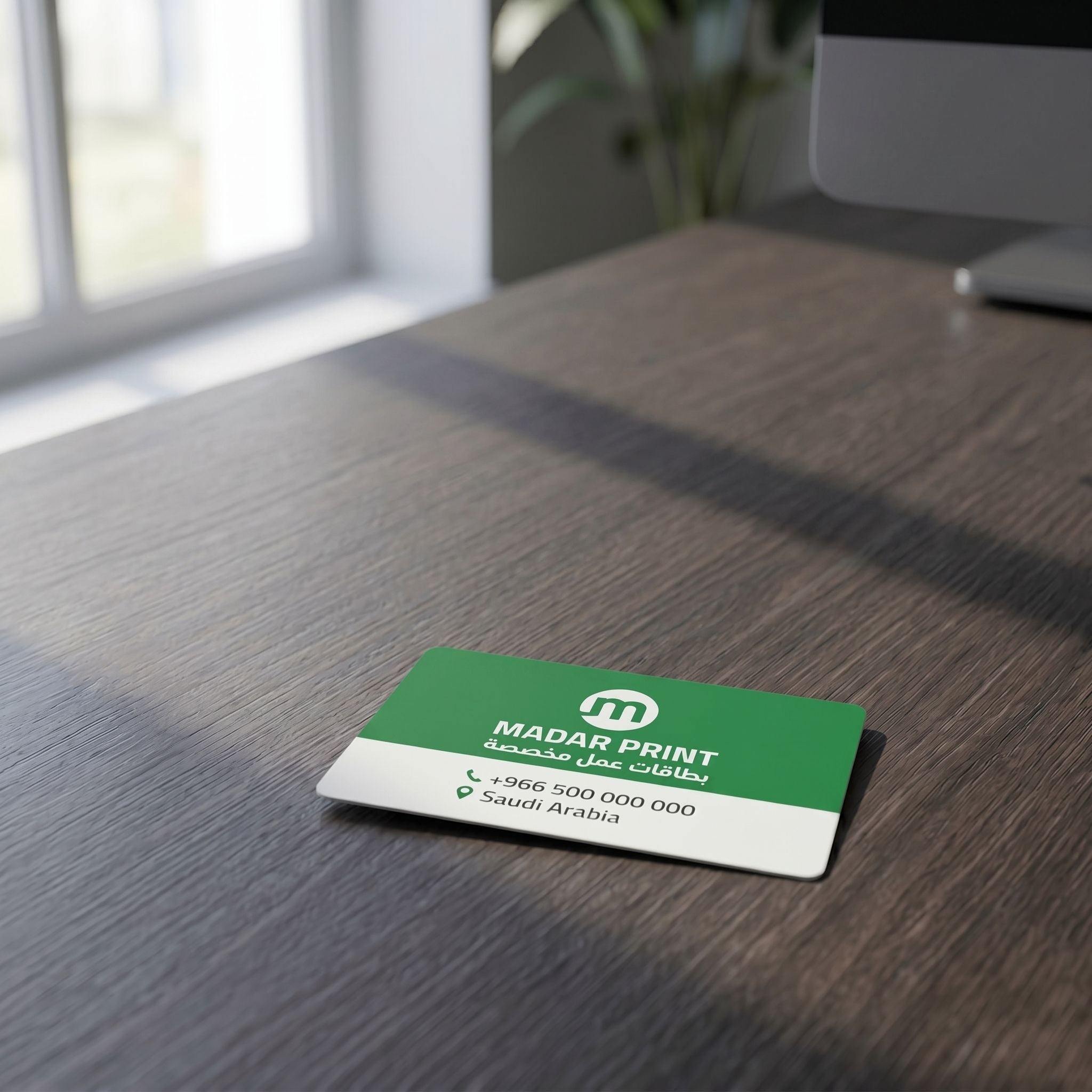 Small full-color ID card with vibrant design placed on textured dark wooden desk in an office setting.
