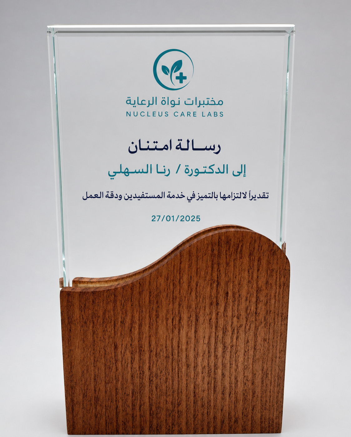 Clear crystal appreciation award with a wood wave base and fictional healthcare recognition engraving